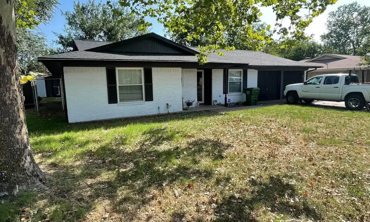 Professional roofing crew working on a residential roof in Goshen